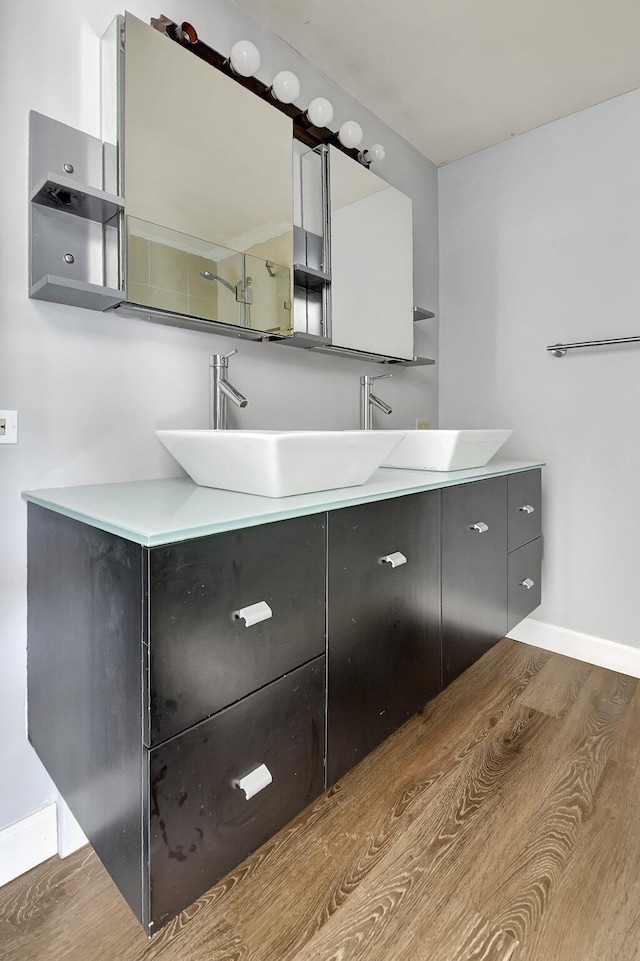 6604 66th Way, West Palm Beach, FL 33409 - full bathroom featuring wood finished floors, vanity, and baseboards