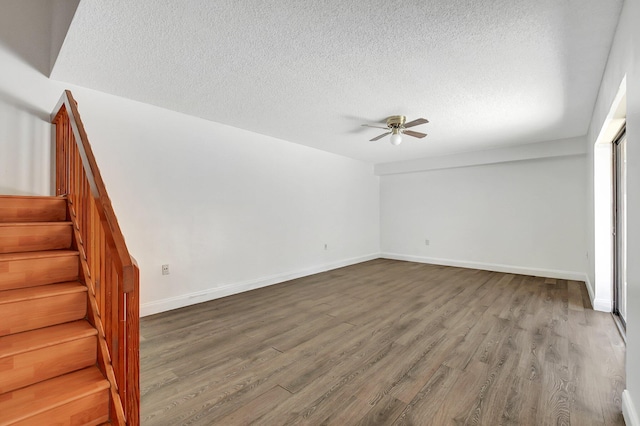 6604 66th Way, West Palm Beach, FL 33409 - unfurnished living room with a textured ceiling, a ceiling fan, stairway, wood finished floors, and baseboards