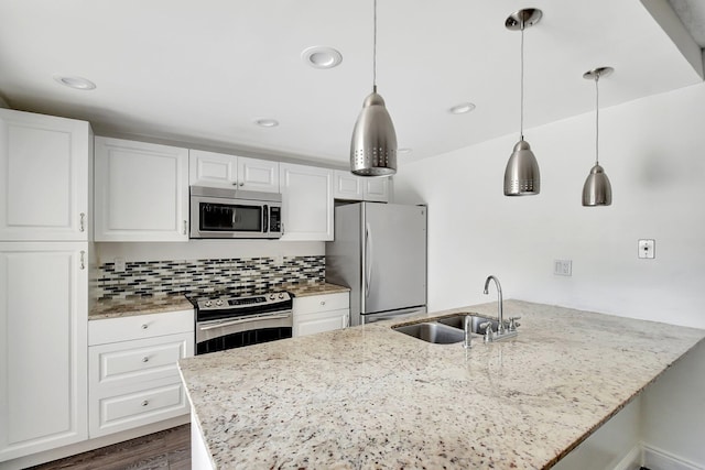 6604 66th Way, West Palm Beach, FL 33409 - kitchen featuring appliances with stainless steel finishes, a sink, white cabinetry, light stone counters, and recessed lighting