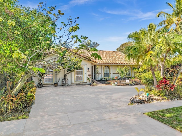 498 Oregon Ln, Boca Raton, FL 33487 - mediterranean / spanish home with stucco siding, a tiled roof, and concrete driveway