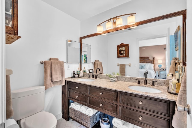 498 Oregon Ln, Boca Raton, FL 33487 - full bathroom with connected bathroom, toilet, double vanity, and tile patterned floors