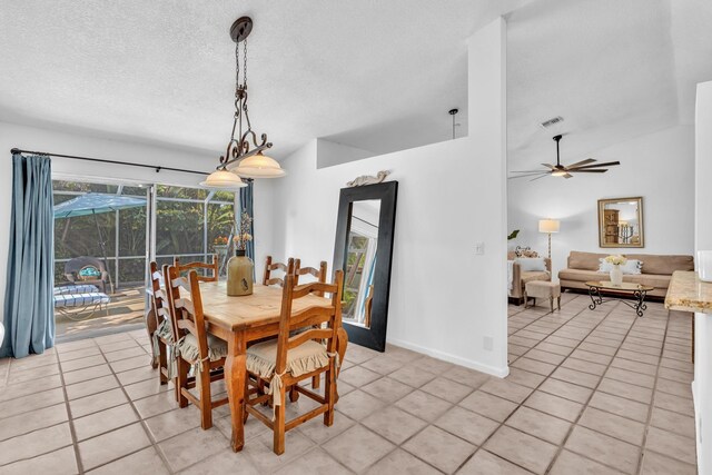 498 Oregon Ln, Boca Raton, FL 33487 - dining room featuring light tile patterned floors, ceiling fan, vaulted ceiling, a textured ceiling, and baseboards