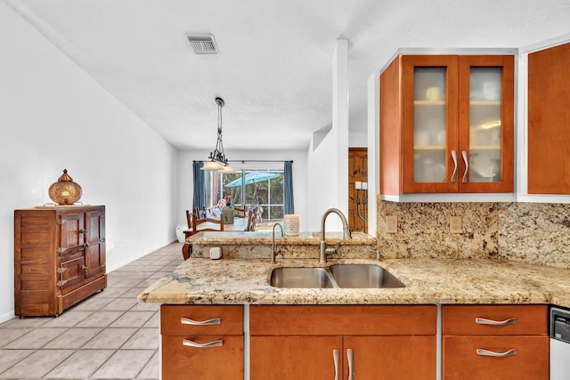 498 Oregon Ln, Boca Raton, FL 33487 - kitchen featuring a sink, decorative backsplash, light tile patterned flooring, and glass insert cabinets