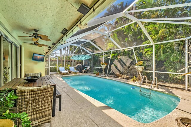 498 Oregon Ln, Boca Raton, FL 33487 - outdoor pool with a patio area, glass enclosure, and a ceiling fan