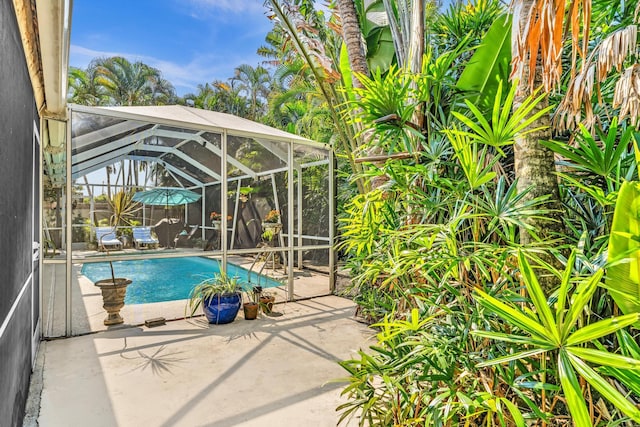 498 Oregon Ln, Boca Raton, FL 33487 - swimming pool featuring glass enclosure and a patio