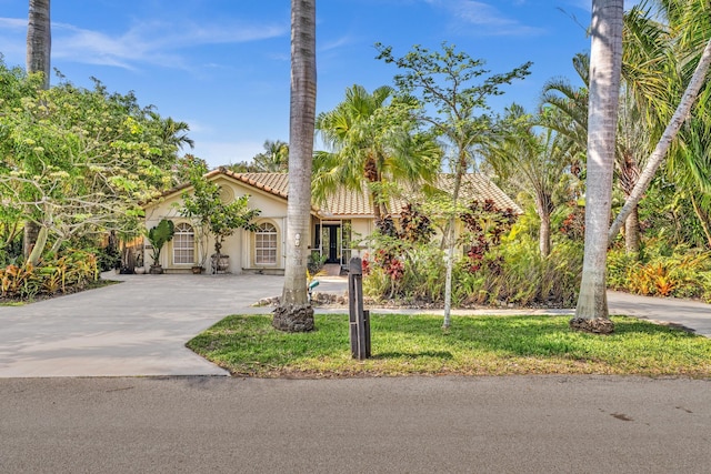 498 Oregon Ln, Boca Raton, FL 33487 - mediterranean / spanish house featuring a tile roof, stucco siding, and concrete driveway