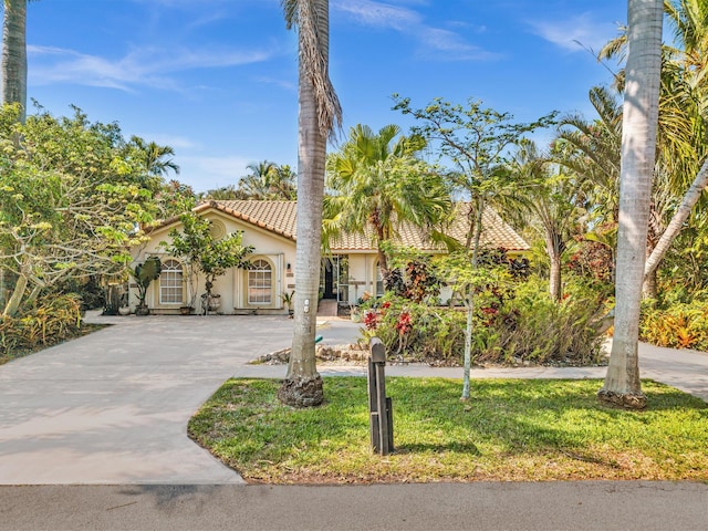 498 Oregon Ln, Boca Raton, FL 33487 - mediterranean / spanish house with stucco siding, a tiled roof, driveway, and a front yard