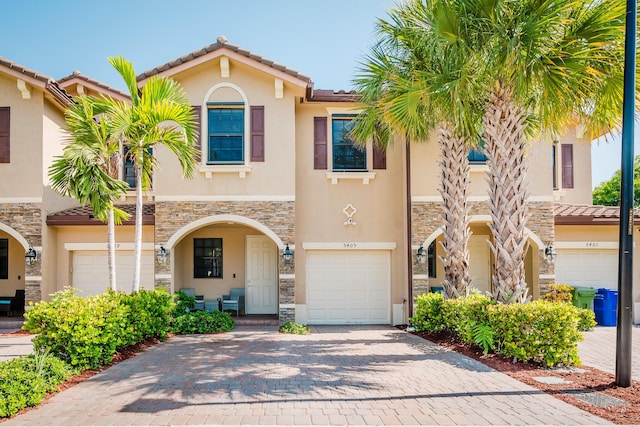5405 NW 27th Ct, Margate, FL 33063 - multi unit property featuring stone siding, a garage, stucco siding, and decorative driveway