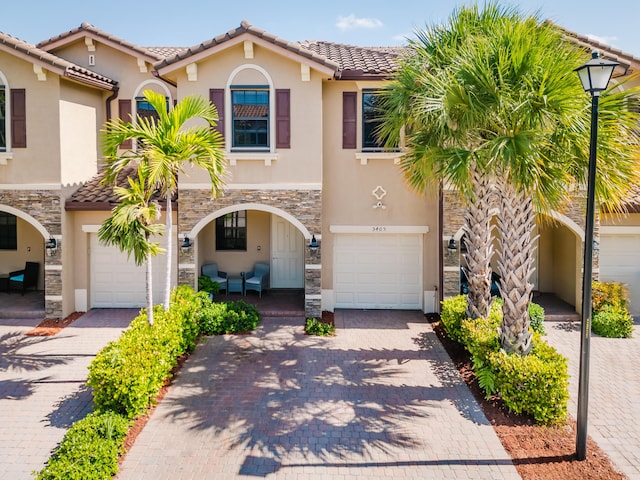 5405 NW 27th Ct, Margate, FL 33063 - townhome / multi-family property featuring stone siding, a garage, and stucco siding