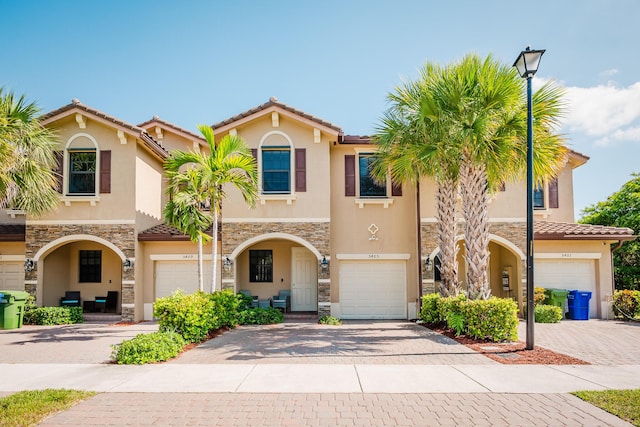 5405 NW 27th Ct, Margate, FL 33063 - view of property with stone siding, stucco siding, and driveway