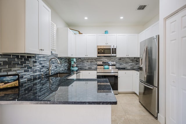 5405 NW 27th Ct, Margate, FL 33063 - kitchen featuring stainless steel appliances, a sink, dark stone counters, backsplash, and recessed lighting