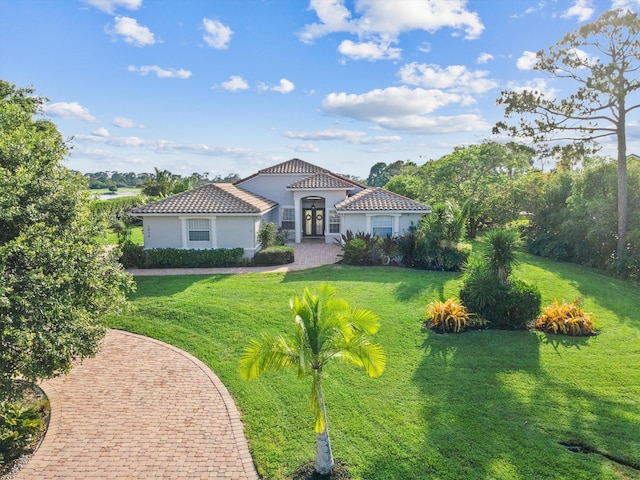 1936 SW Wood Duck Ln, Palm City, FL 34990 - mediterranean / spanish-style home featuring stucco siding and a front lawn