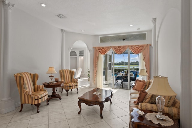 1936 SW Wood Duck Ln, Palm City, FL 34990 - living room featuring arched walkways, light tile patterned flooring, and recessed lighting