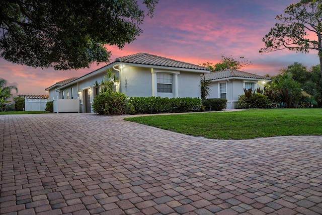 1936 SW Wood Duck Ln, Palm City, FL 34990 - mediterranean / spanish home with decorative driveway, an attached garage, stucco siding, and a tiled roof