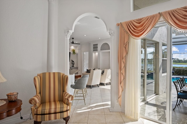 1936 SW Wood Duck Ln, Palm City, FL 34990 - living area with light tile patterned floors, arched walkways, a ceiling fan, and ornate columns