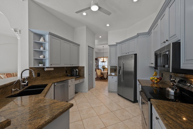 1936 SW Wood Duck Ln, Palm City, FL 34990 - kitchen with stainless steel appliances, a sink, open shelves, gray cabinets, and backsplash