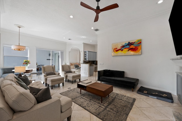 1936 SW Wood Duck Ln, Palm City, FL 34990 - living area featuring ornamental molding, recessed lighting, a ceiling fan, light tile patterned floors, and arched walkways