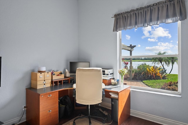 1936 SW Wood Duck Ln, Palm City, FL 34990 - home office with healthy amount of natural light, wood finished floors, and baseboards