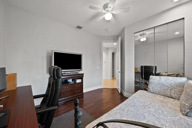 1936 SW Wood Duck Ln, Palm City, FL 34990 - bedroom featuring wood finished floors, an office area, baseboards, a closet, and a ceiling fan