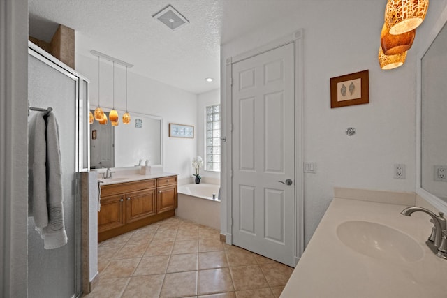 1936 SW Wood Duck Ln, Palm City, FL 34990 - full bath with two vanities, a garden tub, a shower stall, tile patterned flooring, and a textured ceiling