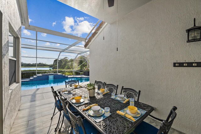 1936 SW Wood Duck Ln, Palm City, FL 34990 - view of pool featuring a patio area, a lanai, outdoor dining space, a water view, and a pool with connected hot tub