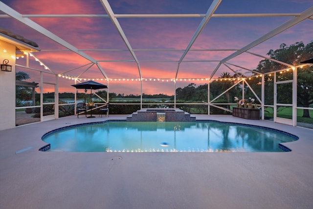 1936 SW Wood Duck Ln, Palm City, FL 34990 - pool at dusk featuring an outdoor pool, a patio area, and a lanai