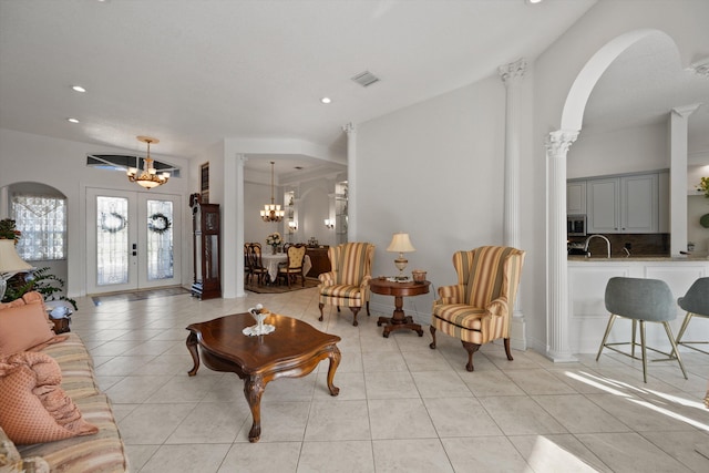 1936 SW Wood Duck Ln, Palm City, FL 34990 - living room featuring a chandelier, arched walkways, french doors, light tile patterned flooring, and recessed lighting