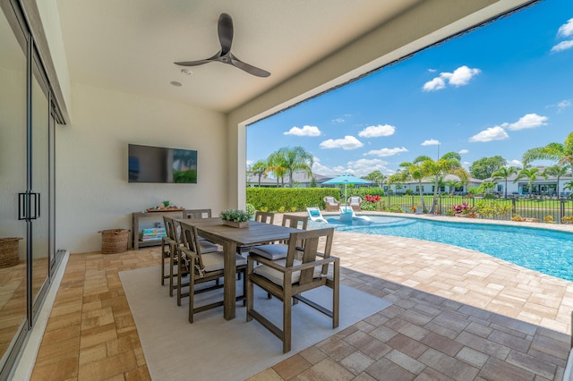 640 SE Boboli Way, Port Saint Lucie, FL 34984 - view of swimming pool featuring a fenced backyard, a patio, ceiling fan, and outdoor dining space