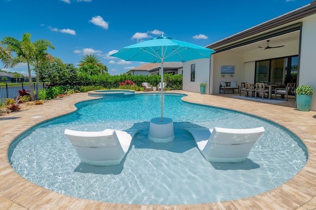 640 SE Boboli Way, Port Saint Lucie, FL 34984 - view of pool with a patio area, a pool with connected hot tub, a ceiling fan, and outdoor dining area