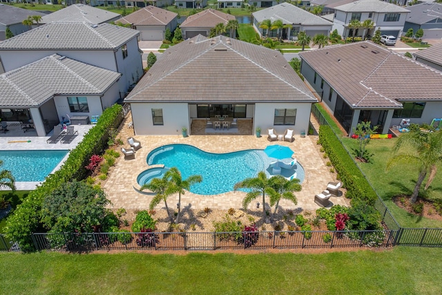 640 SE Boboli Way, Port Saint Lucie, FL 34984 - view of pool featuring a residential view, a pool with connected hot tub, and a patio