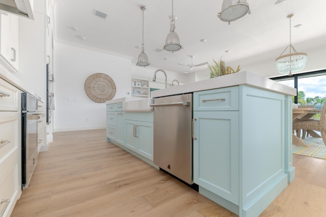 640 SE Boboli Way, Port Saint Lucie, FL 34984 - kitchen with stainless steel dishwasher, a chandelier, blue cabinetry, light countertops, and pendant lighting