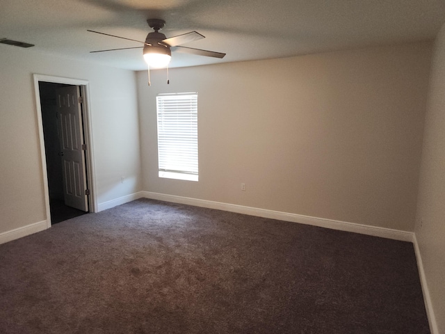 1721 SE Biddle Ln, Port Saint Lucie, FL 34983 - empty room with dark carpet, ceiling fan, and baseboards