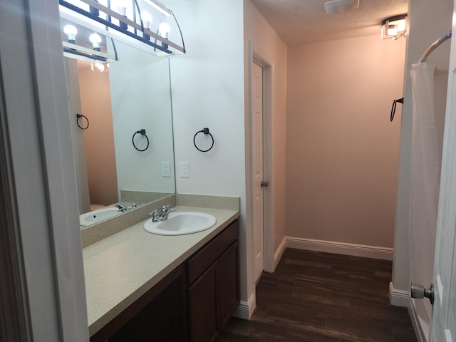 1721 SE Biddle Ln, Port Saint Lucie, FL 34983 - full bathroom with wood finished floors, vanity, curtained shower, and baseboards