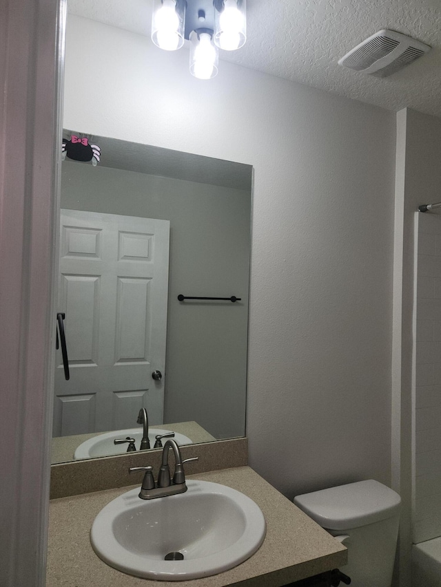 1721 SE Biddle Ln, Port Saint Lucie, FL 34983 - full bath with toilet, vanity, and a textured ceiling