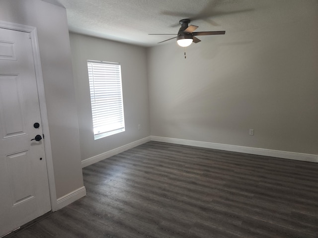 1721 SE Biddle Ln, Port Saint Lucie, FL 34983 - empty room featuring ceiling fan, dark wood-style floors, baseboards, and a textured ceiling