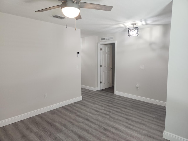 1721 SE Biddle Ln, Port Saint Lucie, FL 34983 - spare room featuring dark wood-style flooring, ceiling fan, and baseboards