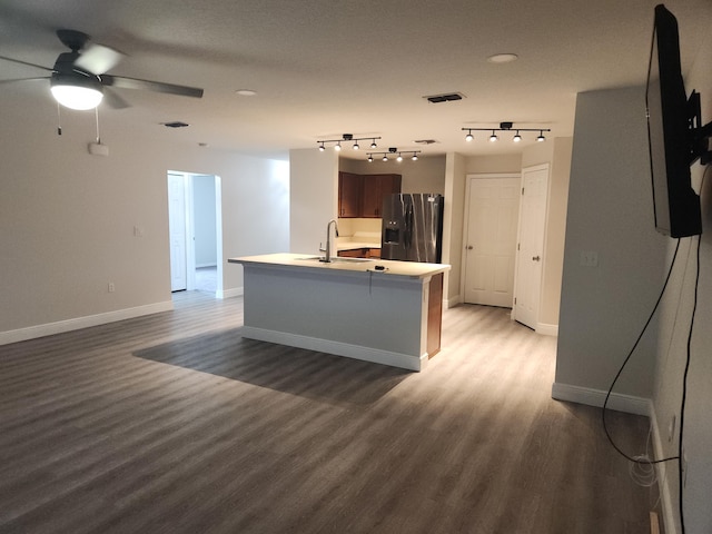 1721 SE Biddle Ln, Port Saint Lucie, FL 34983 - kitchen featuring stainless steel refrigerator with ice dispenser, light wood-style flooring, a ceiling fan, baseboards, and light countertops