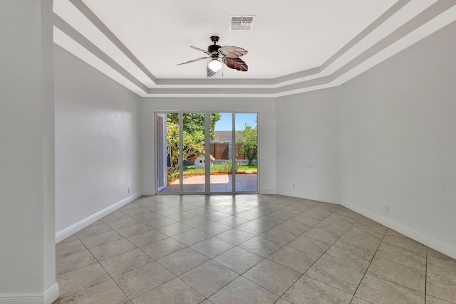1897 SW Citation Ave, Port Saint Lucie, FL 34953 - spare room with a tray ceiling, a ceiling fan, light tile patterned floors, and baseboards