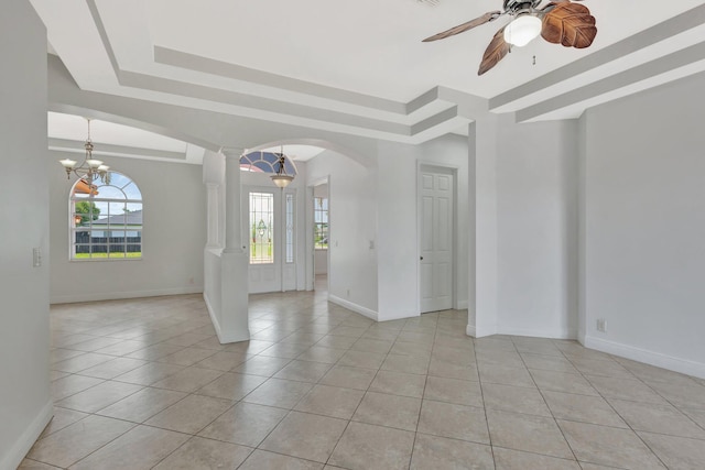 1897 SW Citation Ave, Port Saint Lucie, FL 34953 - empty room with light tile patterned floors, arched walkways, baseboards, and plenty of natural light