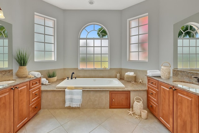 1897 SW Citation Ave, Port Saint Lucie, FL 34953 - full bathroom featuring two vanities, a garden tub, and tile patterned floors