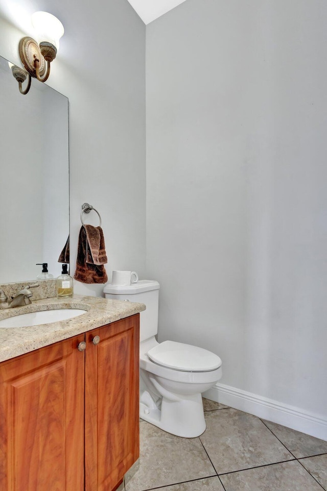 1897 SW Citation Ave, Port Saint Lucie, FL 34953 - half bathroom featuring tile patterned flooring, vanity, toilet, and baseboards
