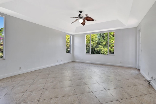 1897 SW Citation Ave, Port Saint Lucie, FL 34953 - unfurnished room with light tile patterned floors, a tray ceiling, ceiling fan, and baseboards