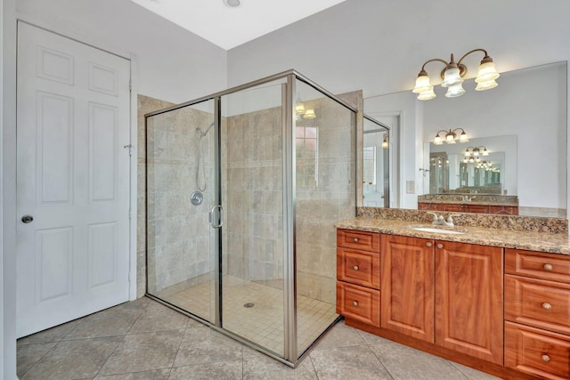 1897 SW Citation Ave, Port Saint Lucie, FL 34953 - bathroom with vanity, a stall shower, a chandelier, and tile patterned floors