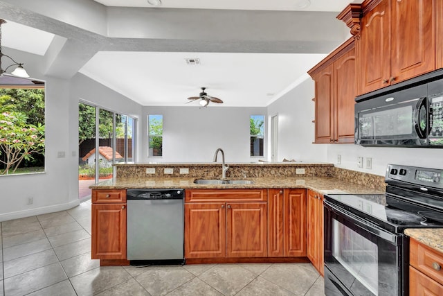 1897 SW Citation Ave, Port Saint Lucie, FL 34953 - kitchen with black appliances, a sink, a peninsula, a ceiling fan, and light stone counters