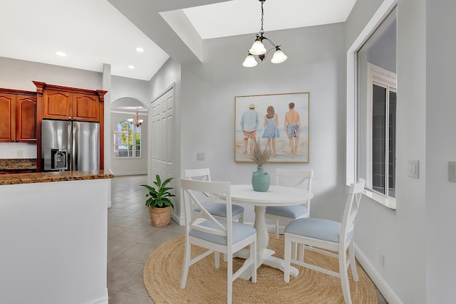 1897 SW Citation Ave, Port Saint Lucie, FL 34953 - dining space featuring a chandelier, light tile patterned flooring, arched walkways, and recessed lighting