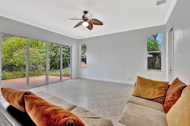 1897 SW Citation Ave, Port Saint Lucie, FL 34953 - living room featuring light tile patterned flooring, ceiling fan, ornamental molding, and baseboards