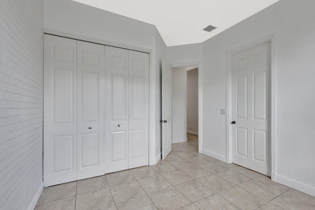 1897 SW Citation Ave, Port Saint Lucie, FL 34953 - unfurnished bedroom with light tile patterned floors, a closet, and baseboards