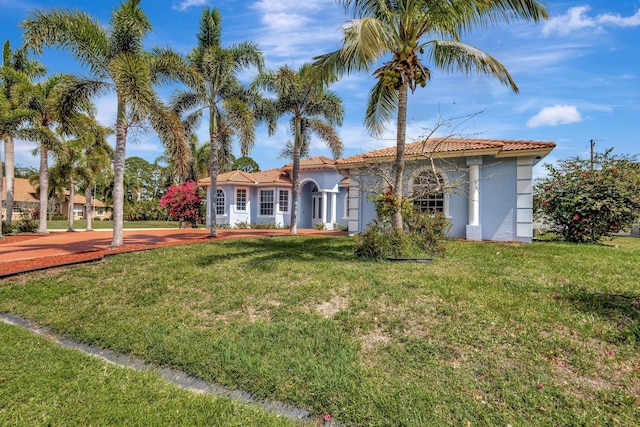 1897 SW Citation Ave, Port Saint Lucie, FL 34953 - mediterranean / spanish home with stucco siding, a tile roof, and a front yard