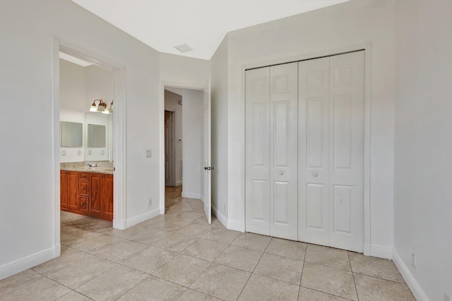 1897 SW Citation Ave, Port Saint Lucie, FL 34953 - unfurnished bedroom featuring light tile patterned flooring, a closet, and baseboards