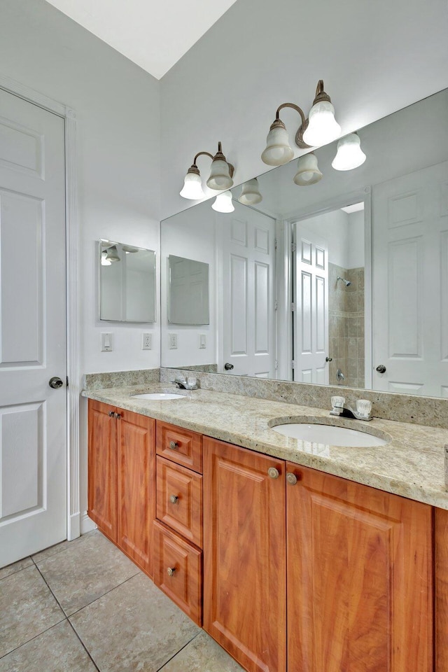 1897 SW Citation Ave, Port Saint Lucie, FL 34953 - bathroom featuring tiled shower, double vanity, and tile patterned flooring